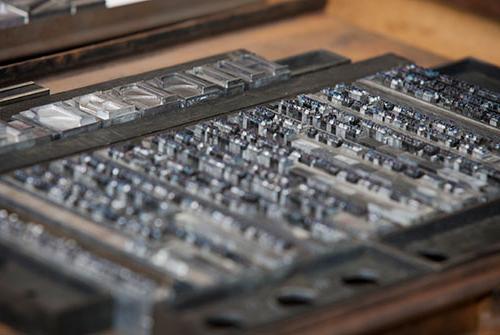 Letterpress metal letters in printing press